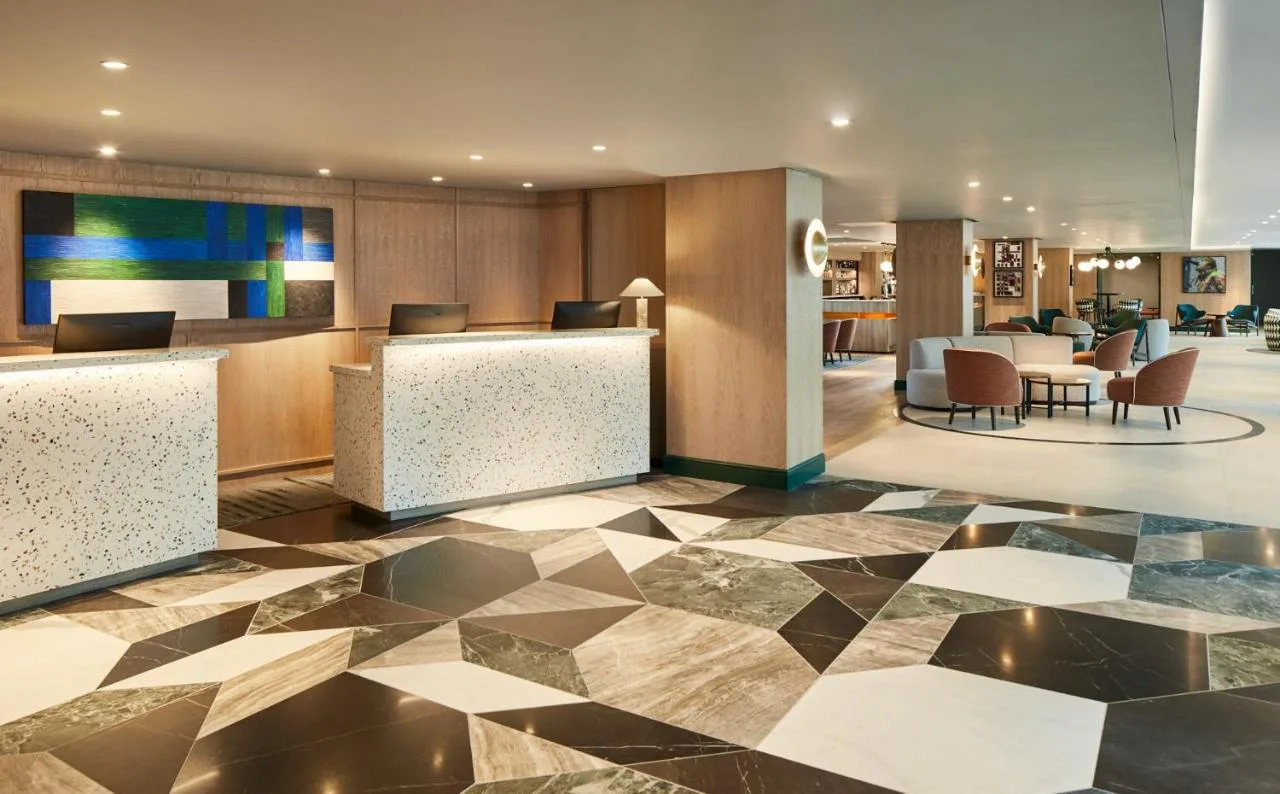 a lobby of a hotel with a check in counter at Manchester Marriott Hotel Piccadilly in Manchester